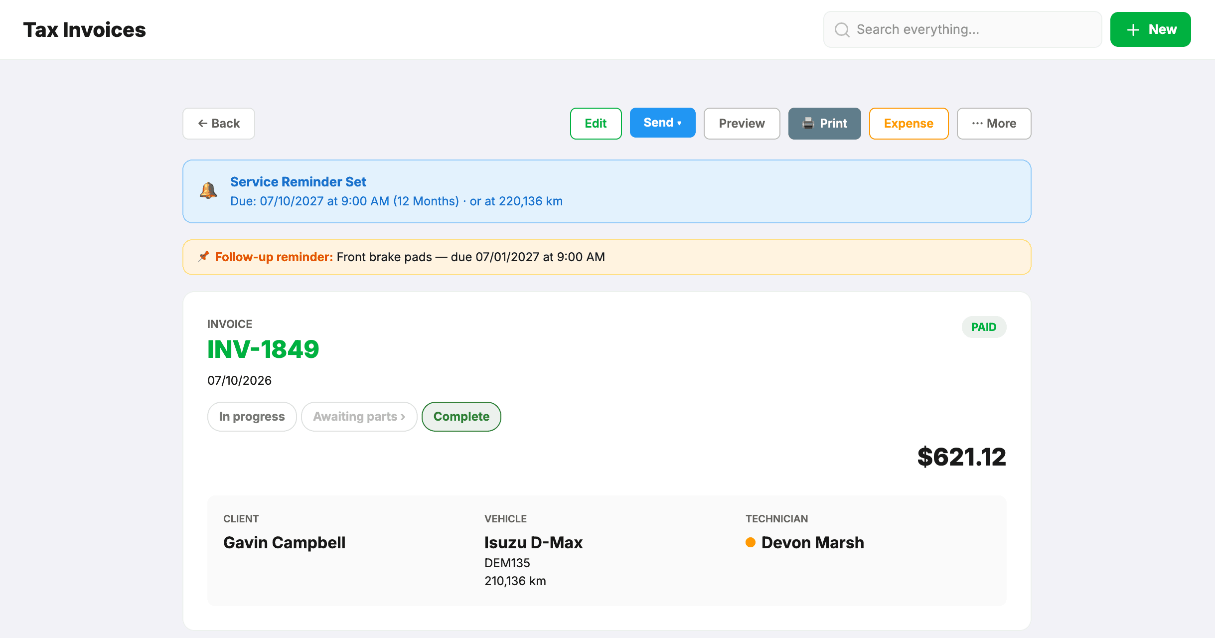 An invoice with a blue Service Reminder Set banner (due 07/10/2027 or at 220,136 km) and a follow-up reminder for front brake pads, above the invoice details